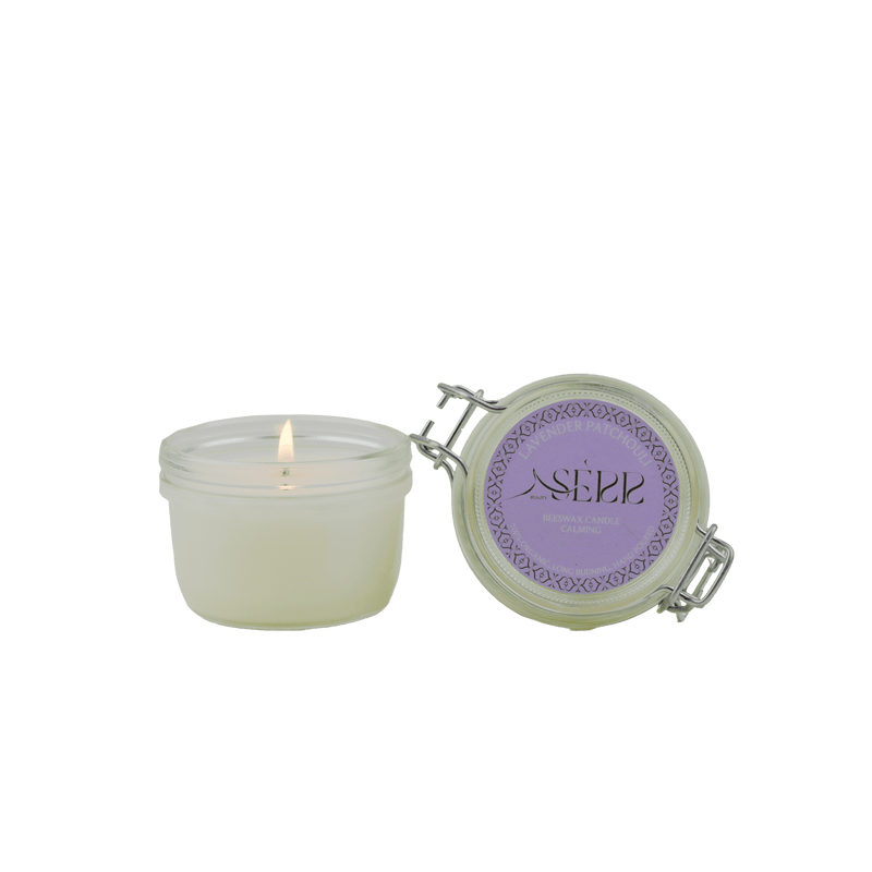 SerrBeauty Lavender & Patchouli Beeswax Scented Candle in a glass jar with a secure lid. Handcrafted organic candle infused with essential oils for a calming ambiance.