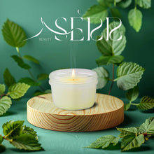 SerrBeauty Peppermint Beeswax Scented Candle 125 G in a frosted glass jar, placed on a wooden stand, surrounded by fresh peppermint leaves. Made from organic beeswax, this eco-friendly candle offers a refreshing and calming peppermint aroma for relaxation and mental clarity.