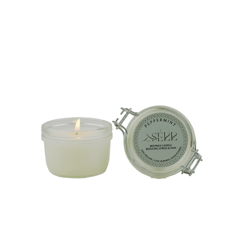SerrBeauty Peppermint Beeswax Scented Candle 125 G in a glass jar with a lit wick, releasing a refreshing peppermint aroma. Made from organic beeswax for a calming and eco-friendly home fragrance experience.