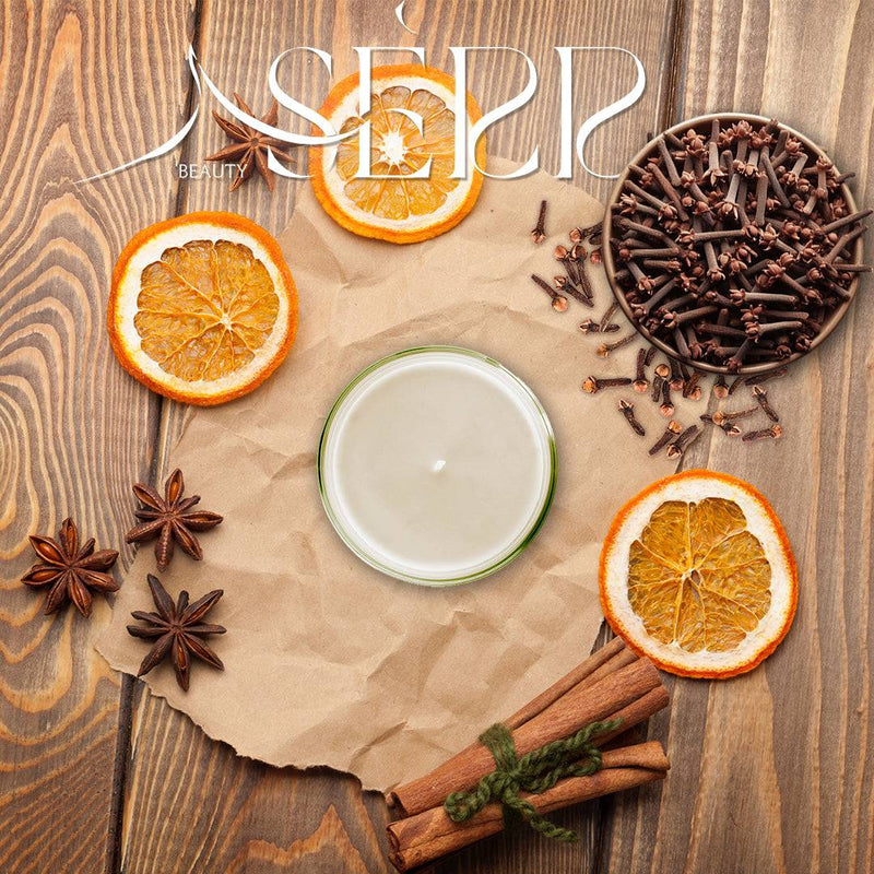 SerrBeauty Cinnamon, Clove & Orange Beeswax Scented Candle 125 G, surrounded by dried orange slices, cinnamon sticks, star anise, and cloves on a rustic wooden surface. Handcrafted with organic beeswax for a warm and inviting home fragrance.