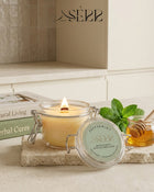 SerrBeauty peppermint beeswax candle 125g burning in a glass jar with fresh natural styling