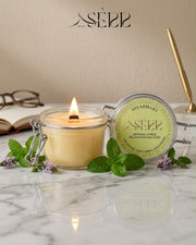 Spearmary beeswax candle 125g burning in a glass jar with natural styling