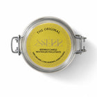 Glass jar with metal clasp lid containing natural beeswax candle with wooden wick, yellow label with black text, decorative border, SKU: 001