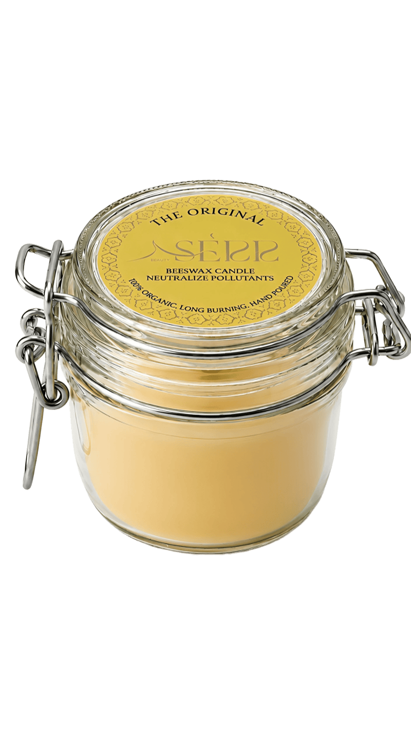 Natural beeswax candle in a clear glass jar with a wooden wick, yellow label, and metal clasp, designed for home ambiance and relaxation.