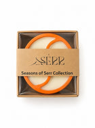 Top view of Seasons of Serr candle with label and packaging