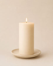 Everyday unscented rapeseed wax pillar candle 200g burning on a ceramic plate