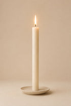 Everyday unscented rapeseed wax pillar candle 25g burning on a ceramic plate