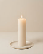 Everyday unscented rapeseed wax pillar candle 44g burning on a ceramic plate