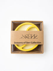 Top view of Seasons of Serr candle with label and packaging